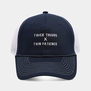 Detailed embroidery text on two-tone mesh trucker hat with breathable white netting
