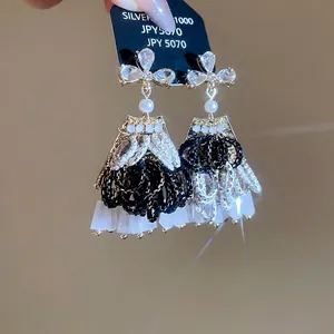 Elegant beaded flower tassel earrings with crystals and pearl accents in a vintage style