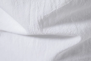Macro shot of white cotton-linen fabric showing natural texture and woven details