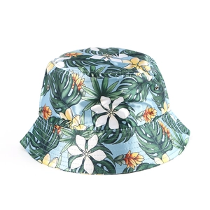 Detailed view of the tropical floral print on a wide-brimmed simulated silk bucket hat