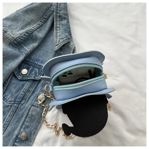 Detail view of the pancake-shaped crossbody bag interior showing phone storage space