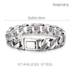 Macro view of silver stainless steel Cuban chain bracelet with Greek fret pattern engraving