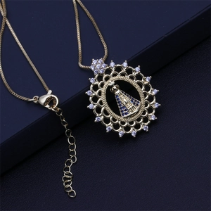 Detailed macro view of gold-plated religious icon pendant with white and blue zircons