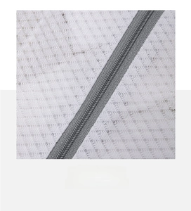 Close-up of fine mesh laundry bag with gray zipper showing durable stitching detail