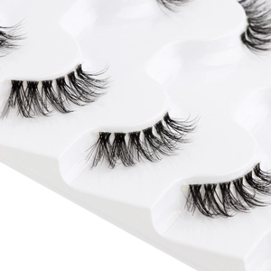 Close-up of six pairs of black half false eyelashes neatly arranged in a tray