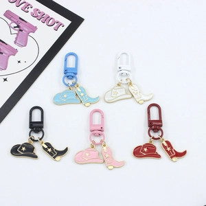Macro detail of alloy western cowboy boot and hat enamel keychains in five colors