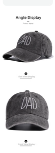 Close-up detail of white DAD embroidery on washed dark gray cotton baseball cap