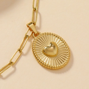 Gold stainless steel oval pendant necklace with heart motif and paperclip chain