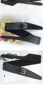 Detail of black elastic corset belt with a gold rectangular metal buckle for dresses
