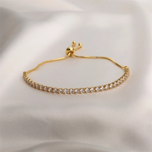Detail of adjustable gold-plated copper tennis bracelet with sparkling cubic zirconia