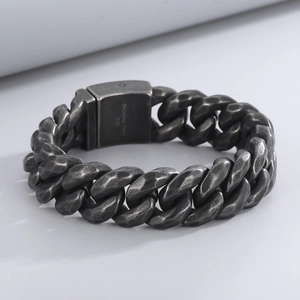 Detail of 316L stainless steel clasp with hammered texture on a Cuban chain bracelet