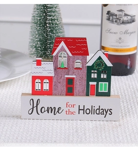 Close-up of wooden Christmas house decor with Home for the Holidays text and festive setup