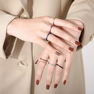 Minimalist 2mm stainless steel skinny rings in multiple colors worn by a model