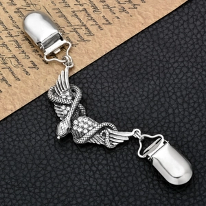 Macro shot of silver snake wings cardigan clip with rhinestones and duckbill clasp