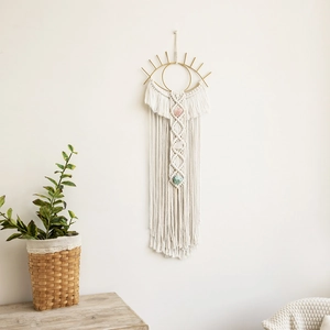 Detailed close-up of woven cotton macrame with colorful gemstones and evil eye motif
