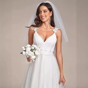Elegant white lace V-neck wedding dress with layered tulle skirt and matching bridal veil