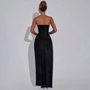 Detail of glittery fabric and slim fit back design on a black strapless slit dress
