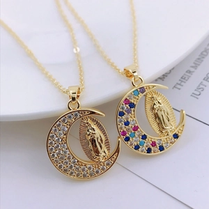 Macro shot of gold crescent moon pendants with Virgin Mary and colorful zircon crystals