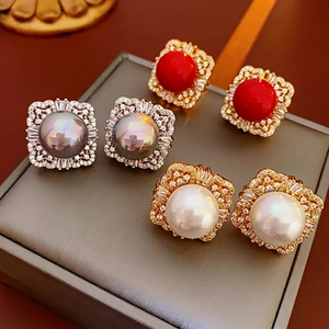 Vintage pearl earrings with zircon inlay in red, grey, and white variants on display