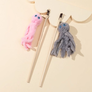 Detail of wooden cat wand with plush octopus pendant in pink and grey tones