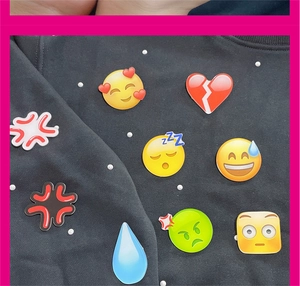 Detailed macro view of high-gloss emoji acrylic patches including sweat and sleepy faces