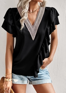 Close-up of black V-neck lace patchwork top with elegant ruffle sleeve details