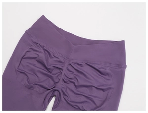Close-up of seamless purple scrunch butt yoga leggings with high-waisted ribbed fabric