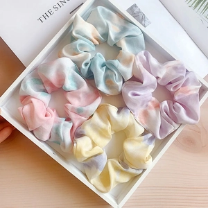 Colorful tie-dye mesh scrunchies set with soft macaron gradients in a stylish tray