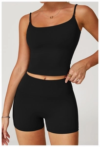 Detail of black cross back yoga crop top and high waist sports shorts on a model