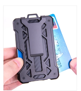 Detail of hand holding slim RFID carbon fiber card wallet with durable metal money clip