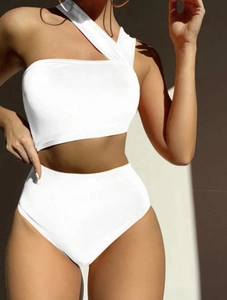 Detailed view of white one-shoulder bikini with high-waisted bottom and elegant side cutouts