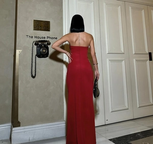 Detailed back view of a red strapless satin gown featuring an elegant open back design