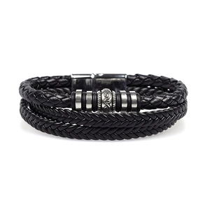 Close-up of a multi-layer black braided leather bracelet with patterned metal beads
