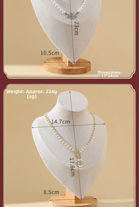 Close-up of beige velvet necklace bust display stand with light wood round base