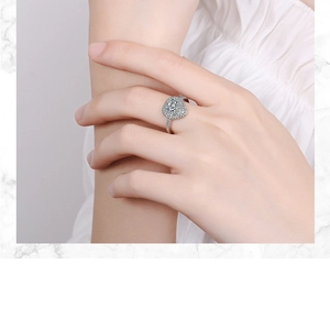 Close-up of sparkling halo zirconia ring with a large round center stone on a hand
