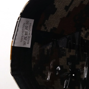 Detail view of cotton camo baseball cap showing 100% cotton label and inner stitching