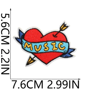 Macro detail of red heart embroidery patch with music banner and dimensions 7.6cm x 5.6cm