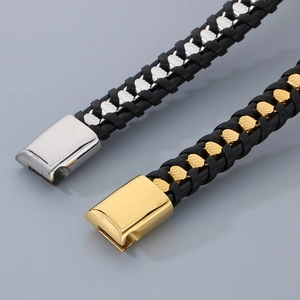 Macro shot of black braided leather bracelets with gold and silver magnetic metal clasps