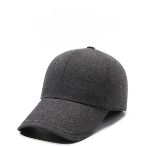 Detail of dark grey winter baseball cap showing thick fleece fabric and metal logo accent
