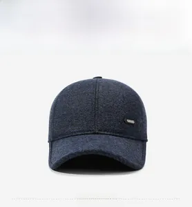 Detail of winter baseball cap showing thick knit fabric and side metal emblem