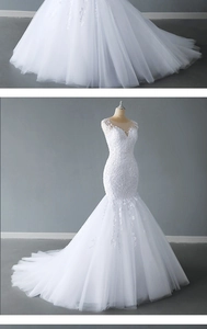 Detailed close-up of intricate lace embroidery and sequin beads on a white V-neck bridal gown
