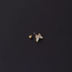 Golden butterfly cartilage stud with white zircon inlay on a sleek black background