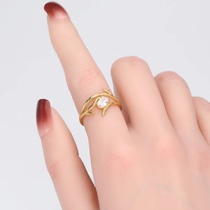 Detail of adjustable silver ring with gold plating and oval zircon on finger