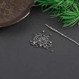 Macro shot of polished silver-plated smooth round spacer beads for DIY jewelry making