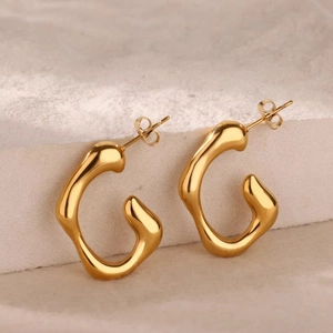 Macro detail of 18K gold plated stainless steel irregular liquid texture stud earrings