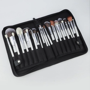 Detail showing 30 professional makeup brushes with white handles in a black zip case