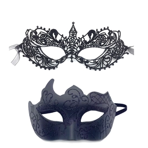 Detail of a black lace phoenix mask and a glittery scroll mask for masquerade parties