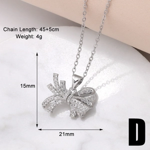 Detailed view of silver bow necklace showing chain length 45+5cm and 21mm pendant size