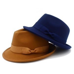 Close-up of wool felt jazz hats in navy blue and camel with matching ribbon bows