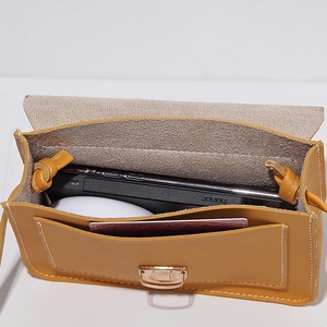 Minimalist yellow PU leather crossbody bag showing internal compartments and flap design